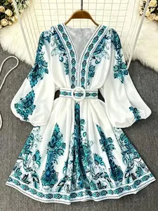 Detailed view of bohemian print dress with V-neckline and elegant lantern sleeves.