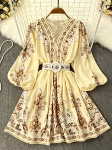 Detailed view of bohemian floral print dress featuring v-neck and matching belt accessory