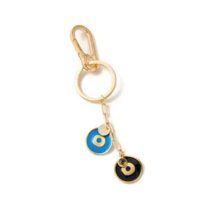 Vista dettagliata del ciondolo per borsa placcato oro 18K con occhi del diavolo blu e neri