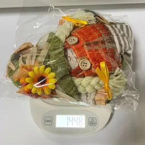 Thanksgiving harvest gnome decoration doll on a white scale showing product weight 144.8g