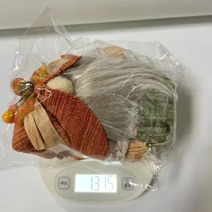 Detail showing weight measurement of a Thanksgiving harvest gnome with maple leaf decoration