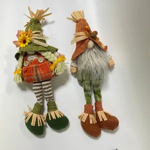 Detailed view of two Thanksgiving harvest gnomes with sunflower and straw accents