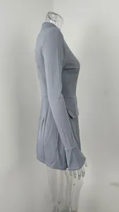 Side view of slim fit long sleeve blue mini dress with pocket detail and flared cuffs.