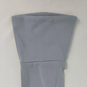 Detailed macro shot of the smooth grey knit fabric and sleeve cuff of a bodycon dress