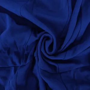 Detailed macro view of the dark blue fabric texture for this elegant long sleeve bodycon dress
