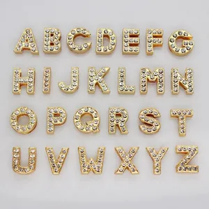 Close-up view of a complete 26-piece gold rhinestone A-Z alphabet bead set for DIY jewelry