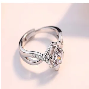 Macro detail of an adjustable silver ring featuring a sparkling central zircon stone