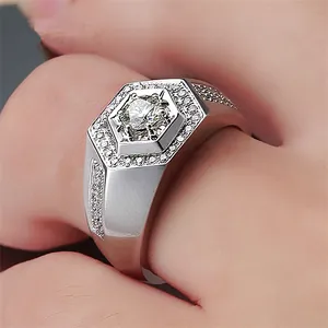 Close-up detail of a men's silver ring with a large hexagonal zircon center stone.