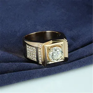 Macro view of a gold-plated men's ring featuring a large center zircon and side stones.