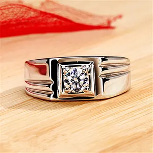 Close-up view of a chunky men's silver ring with a large sparkling central cubic zirconia