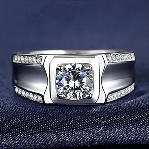 Macro detail of men's sparkling zircon ring with side stone accents on textured blue fabric