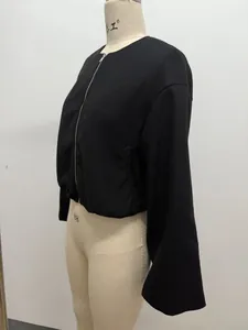 Detailed side view of women's minimalist black soft pilot bomber jacket on dress form