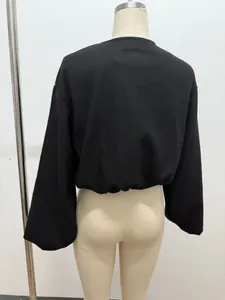 Detailed back view of a black cropped soft bomber jacket with pleated hem for women