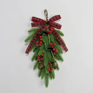 Christmas teardrop swag with pine needles, red berries, cones, and buffalo plaid bow