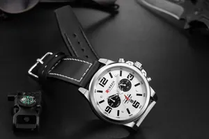 Detailed macro view of the CURREN 8314 men's watch with white dial and black leather strap