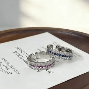 Detail view of French vintage row rings with sapphire and ruby stones on textured band