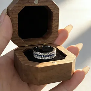 Detailed close-up of a French vintage sapphire and diamond row-set ring in a wooden box.