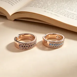 Detail of rose gold wide band rings with purple and turquoise micro-set stones