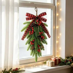 Artificial Christmas teardrop swag with buffalo plaid bow, red berries and bells