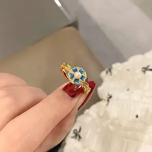 Close-up detail of vintage gradient blue flower open ring with central pearl accent