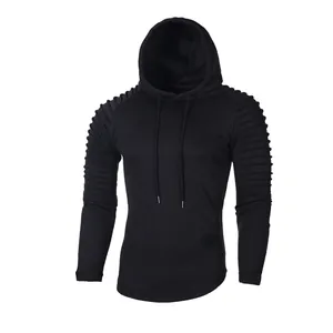 Close-up of men's black hoodie featuring unique pleated texture on raglan sleeves