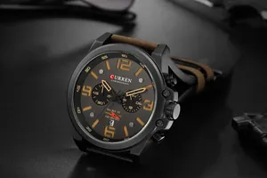 Detail of CURREN 8314 men's chronograph watch with brown leather strap and date display.