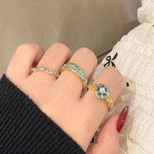 Macro detail of vintage blue floral patterned open rings for women with ethnic style