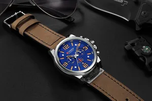 Detailed macro view of CURREN 8314 men's chronograph watch with blue dial and brown leather strap