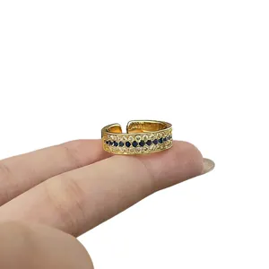 Vintage gold sapphire pavé ring with blue and clear stones shown on a model finger.