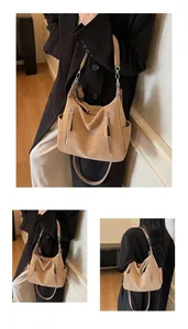 Detailed view of the tan slouchy hobo bag featuring multiple zippers and side pockets