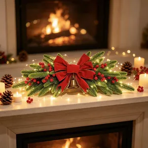 Detailed close-up of Christmas mantel garland with red bow, bell and warm LED lights.