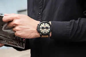 Macro view of CURREN 8314 men's business watch with leather strap and calendar on wrist