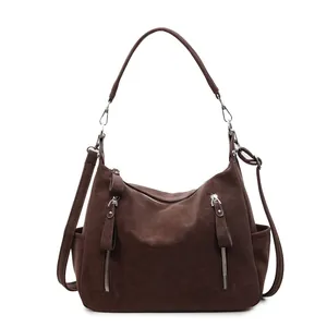 Vintage brown faux leather crossbody bag with multiple zippers and wide shoulder strap