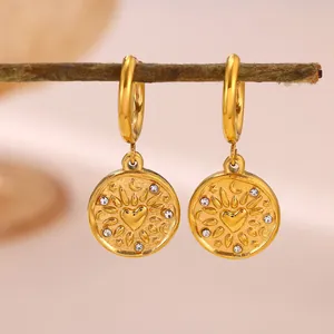 Close-up view of gold stainless steel hoop earrings featuring heart and sun design.