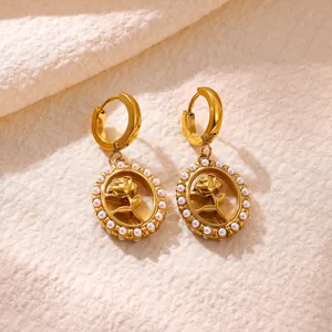 Close-up view of elegant gold-plated stainless steel rose drop earrings with pearl border.