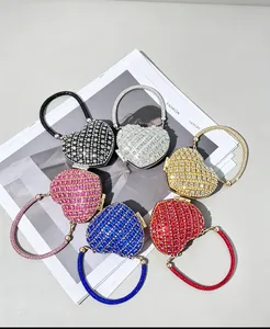 Variété de pochettes de soirée en forme de cœur à strass sur un magazine de mode.