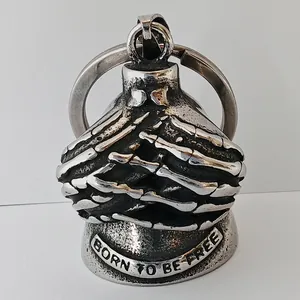 Close-up of skeleton hand motorcycle guardian bell engraved with BORN TO BE FREE.