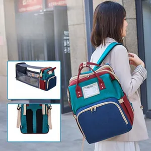 Multifunctional diaper bag with built-in foldable baby crib and breathable back padding.