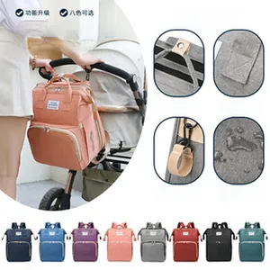 Detail view of waterproof diaper bag with stroller hooks and multi-layer storage.