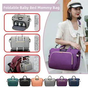 Detail view of multi-functional diaper bag featuring a foldable crib and insulated pockets
