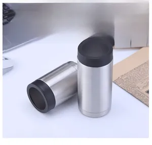 A detailed view showing two stainless steel vacuum insulated can coolers on a white desk
