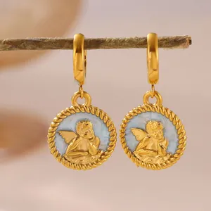 Detailed macro view of exquisite gold cherub drop earrings with light blue enamel finish