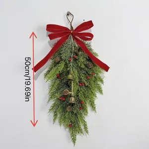 Close-up of 50cm hanging Christmas teardrop swag with red bow, pinecones and bells