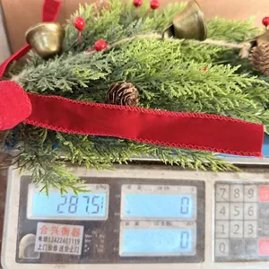 Christmas bell garland hanging decoration weighing approximately 287.5 grams on a scale.