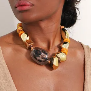 Detail shot of a Bohemian chunky necklace featuring leopard print and polished gold beads