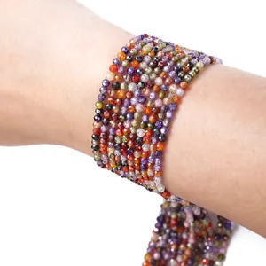 Detailed macro view of multi-color 2-2.5mm faceted natural stone beads wrapped on a wrist.