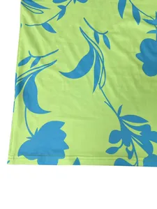 Close-up of the blue floral print and stitched hem on a lime green summer dress