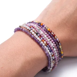 Detailed view of 2-2.5mm faceted natural stone bead bracelets worn on a female wrist
