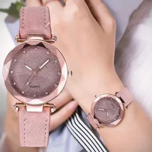 Close-up of elegant women's watch featuring a starry pink dial and frosted leather strap