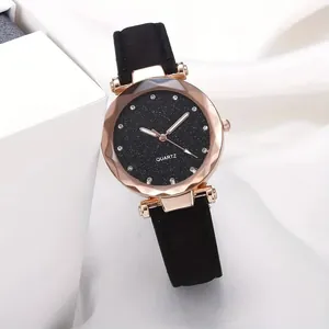 Close-up of women's starry sky dial watch featuring rhinestone markers and black leather strap